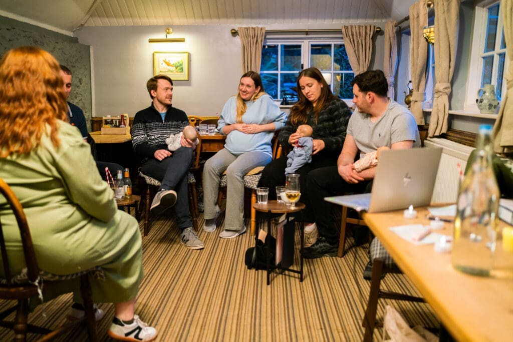 Future parents learning baby care skills together during an antenatal class